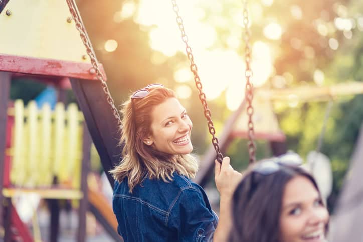Friends swinging in the park