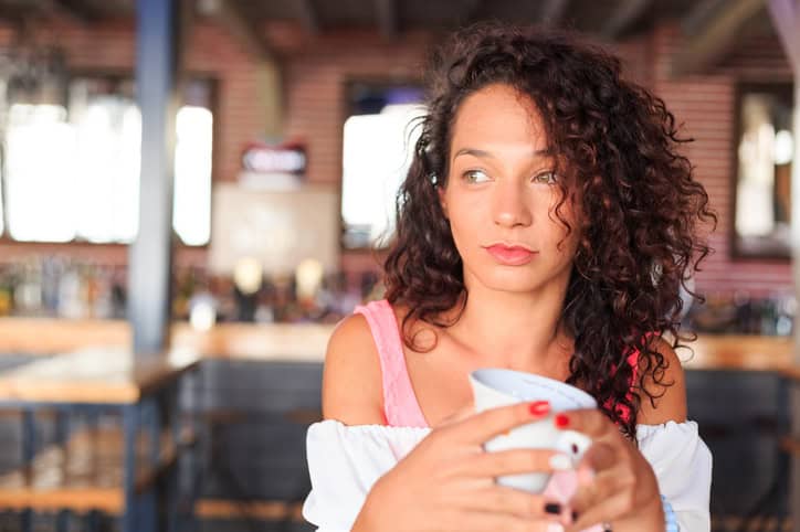 Thoughtful woman drinking coffee.