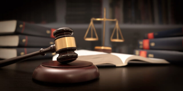 Judge gavel and scale in court.