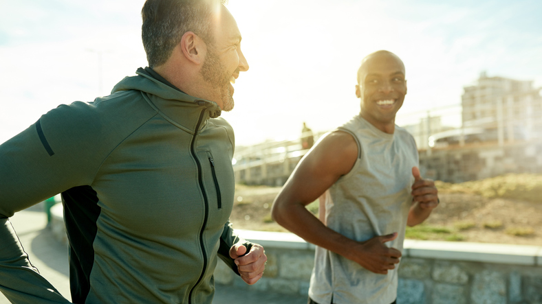 Men exercising together outdoors.