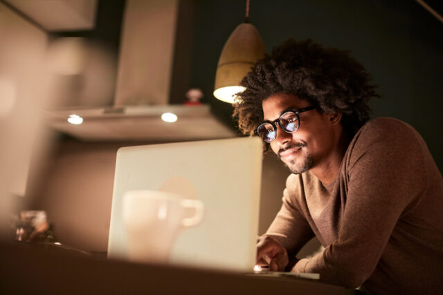 guy working at his laptop at night