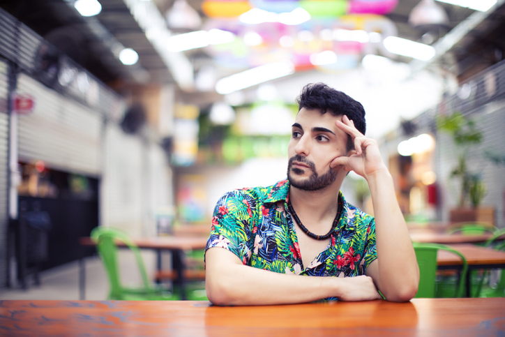 Portrait of young man sitting in a cafe.