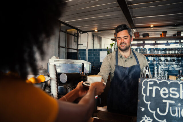 woman getting her coffee from barista