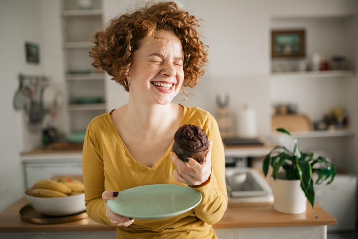 Woman enjoying a muffin breakfast.