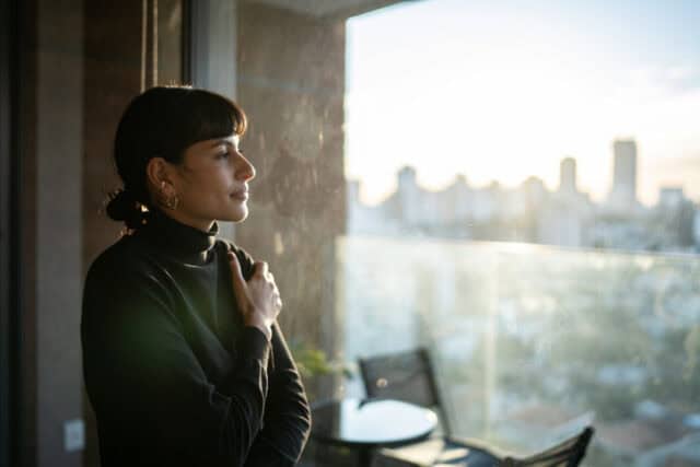 Young woman contemplating at home thinking