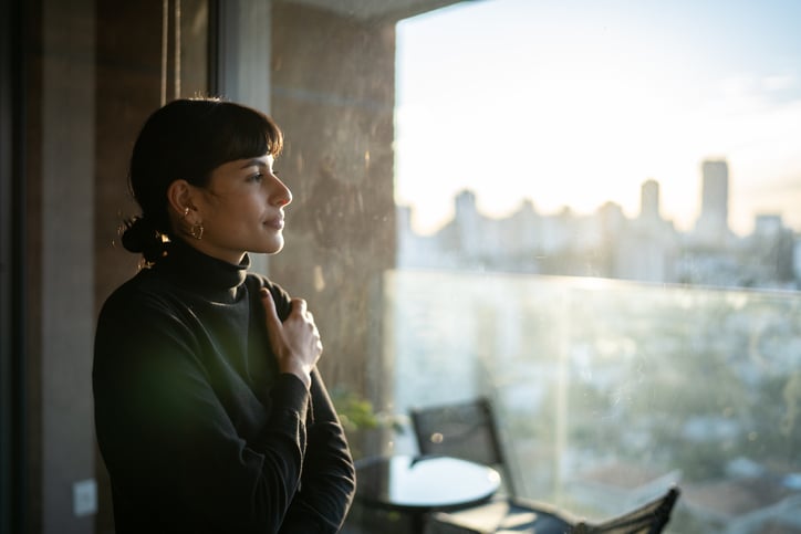 Young woman contemplating at home thinking