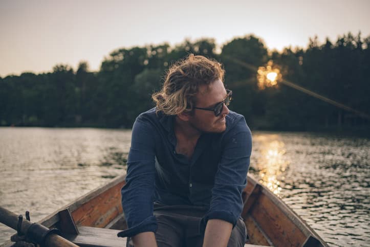 Man rowing boat outdoors.