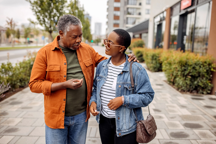 Senior father enjoys walk with his daughter in the city