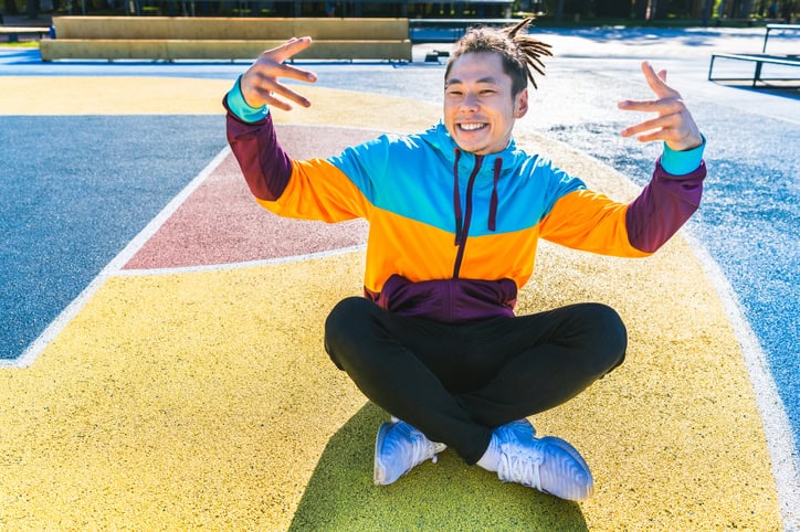 guy sitting on colorful basketball court