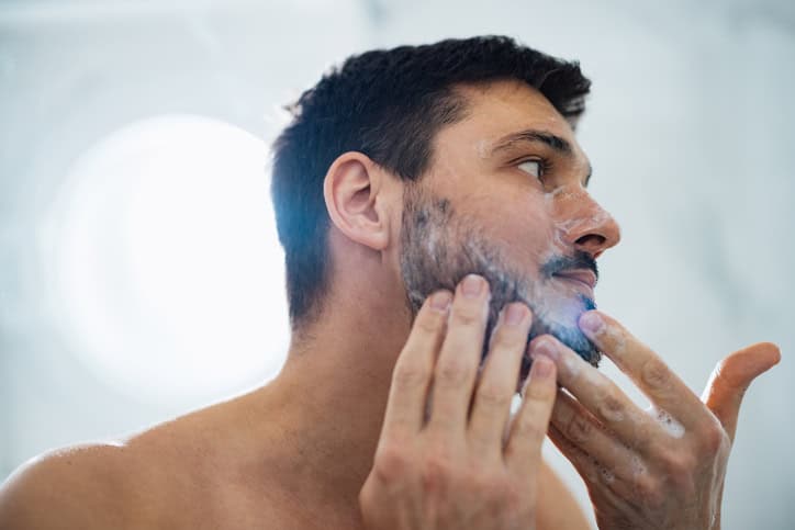 Man using face soap in the morning.