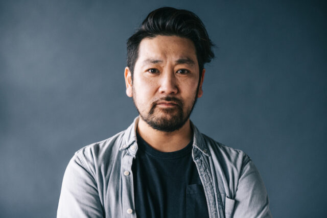 man with crossed arms looking serious