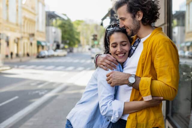 couple embracing on city street