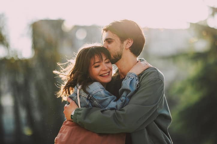sensitive couple embracing outside