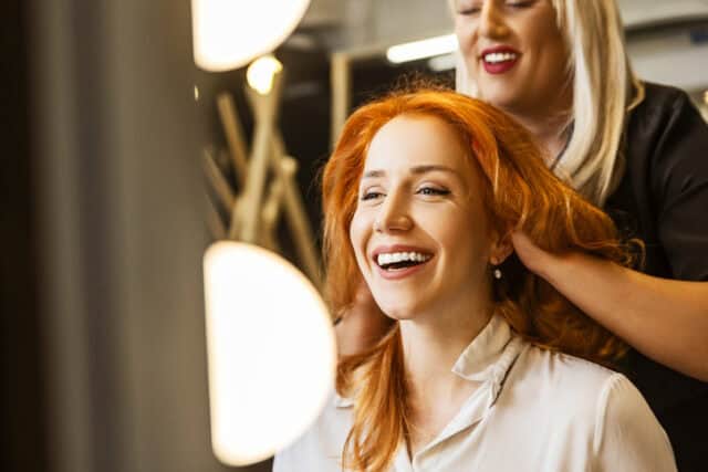 woman with red hair at salon