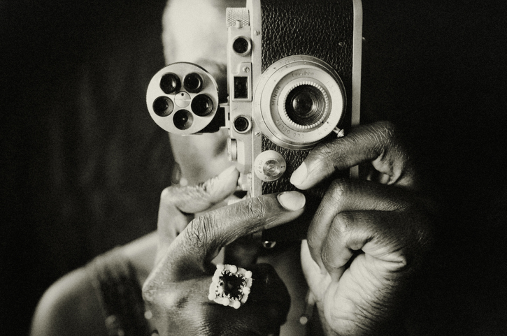 Female photographer taking a picture with an old analog camera.