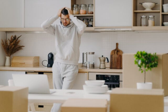 guy looking stressed in kitchen 