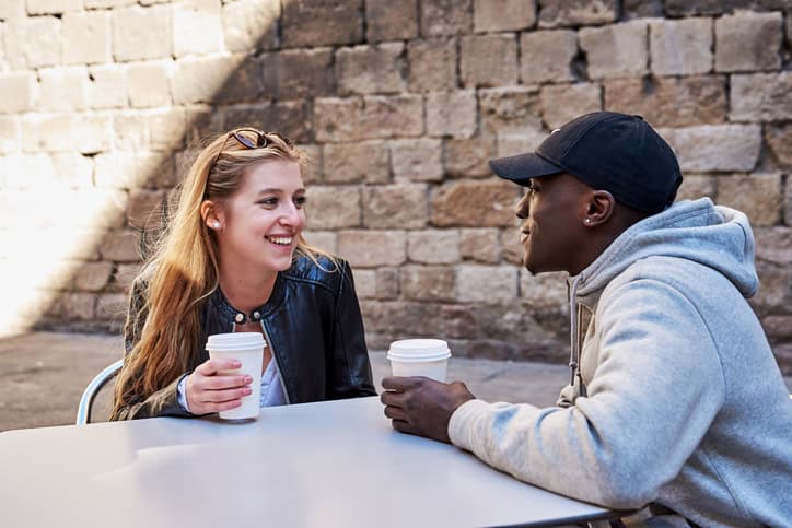 male and female having coffee together