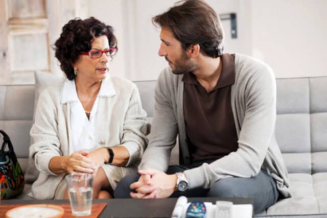 adult man talking to mother