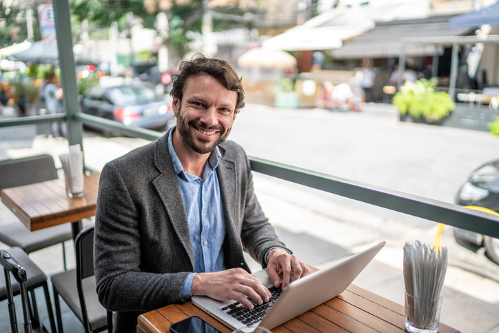 Portrait of a businessman using his laptop in a restaurant.