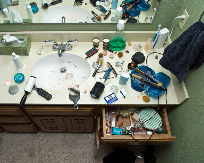 Messy bathroom counter and sink.
