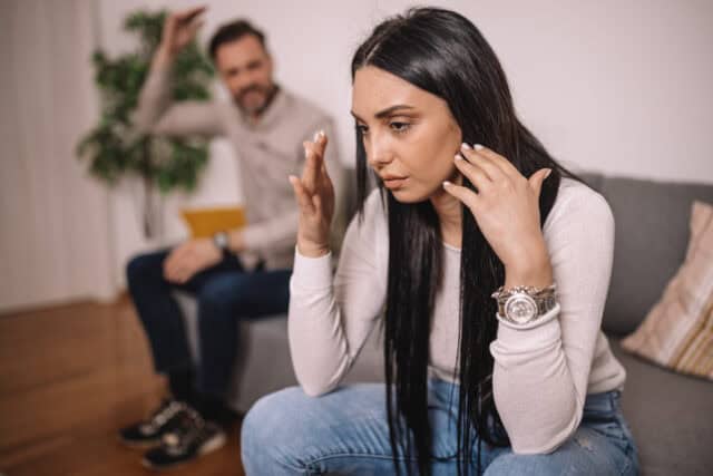 he man speaks while the woman remains silent, highlighting a breakdown in communication