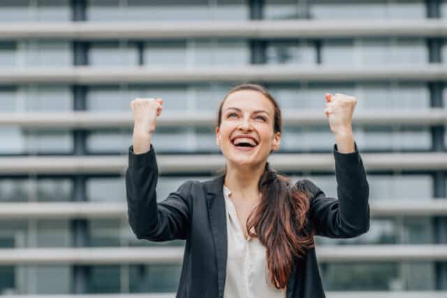 Excited business woman celebrating success.