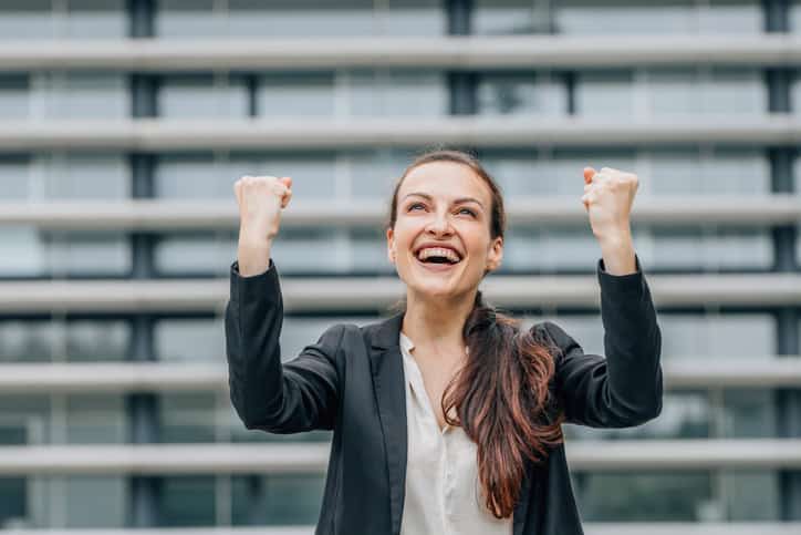 Excited business woman celebrating success.
