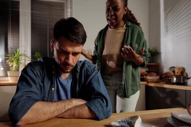 Young stressed man with his angry wife.