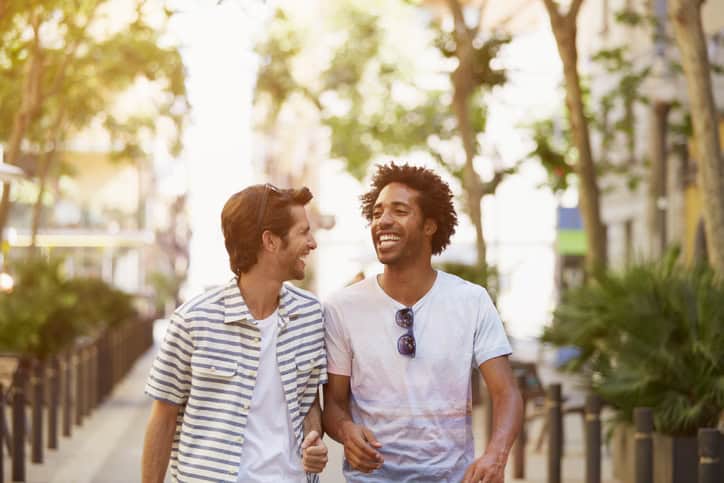 Male friends walking outdoors.