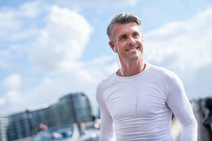 Man running outdoors and listening to music.