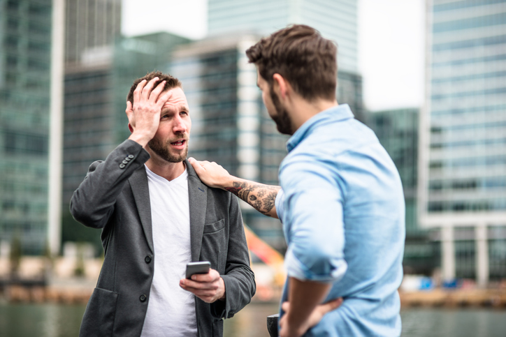 Two men arguing in public.