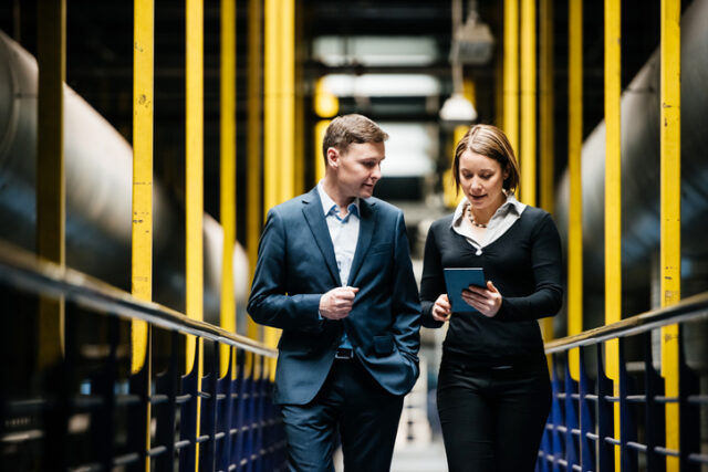 two colleagues waking in office