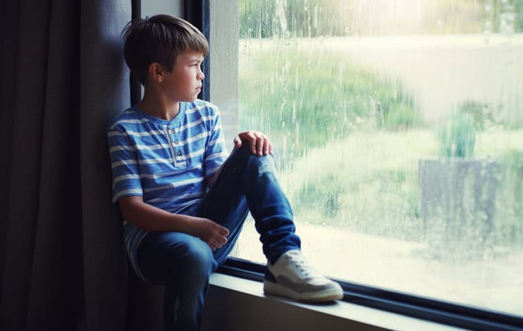 kid looking out window upset