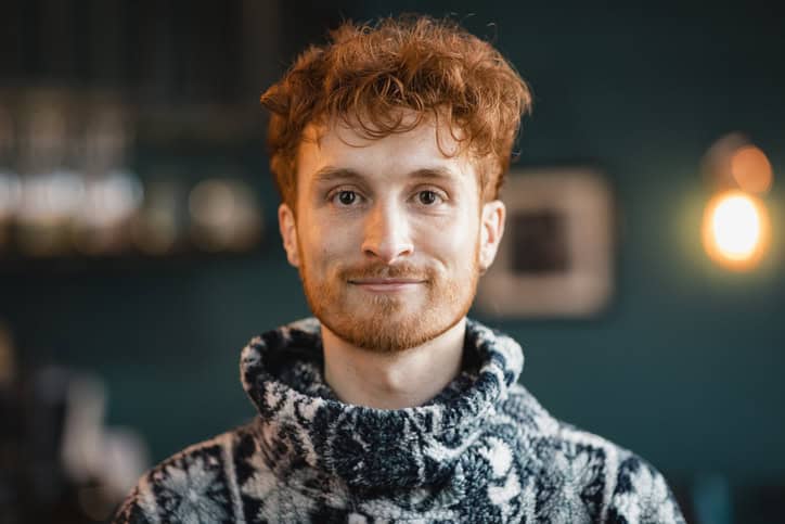 young readhead guy smiling at camera