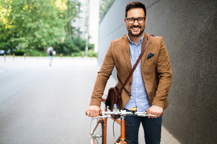 Young businessman going to work by bike.