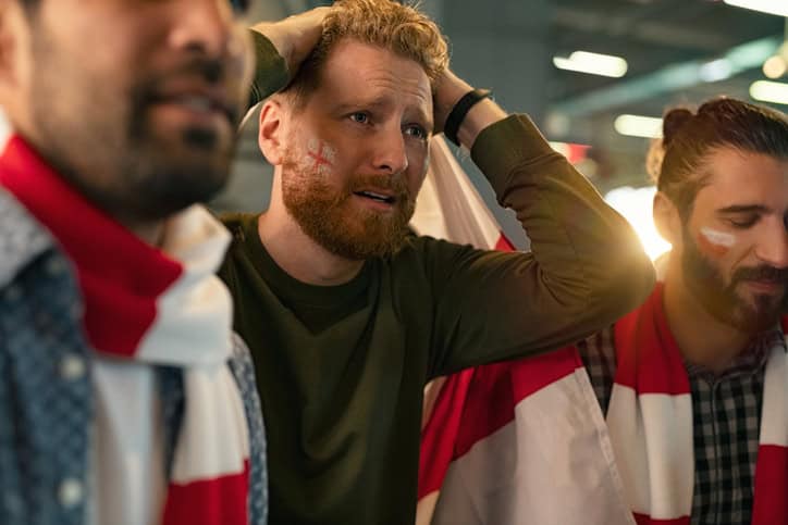 Upset men watching their football team lose.