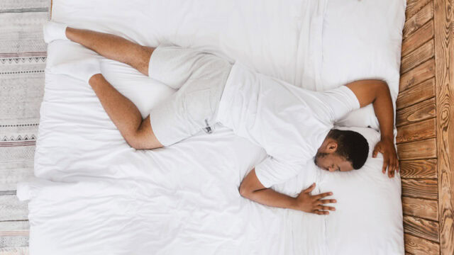 Man asleep on his stomach.