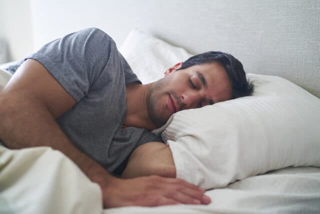 Man sleeping in bed.