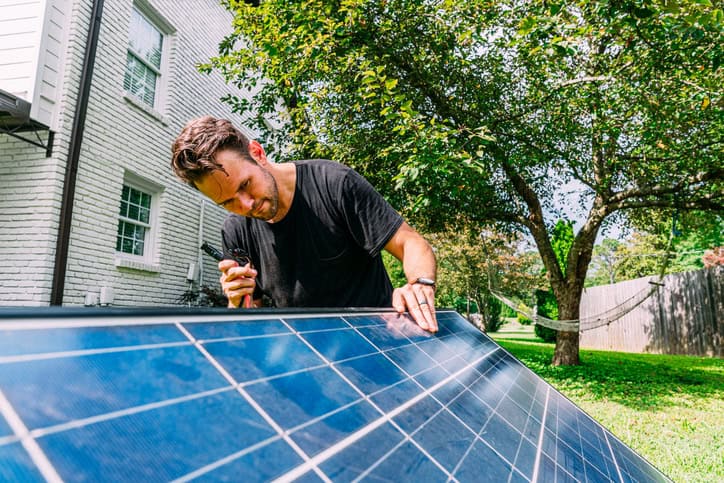 A man inspecting solar panels.