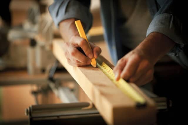 guy measuring wood