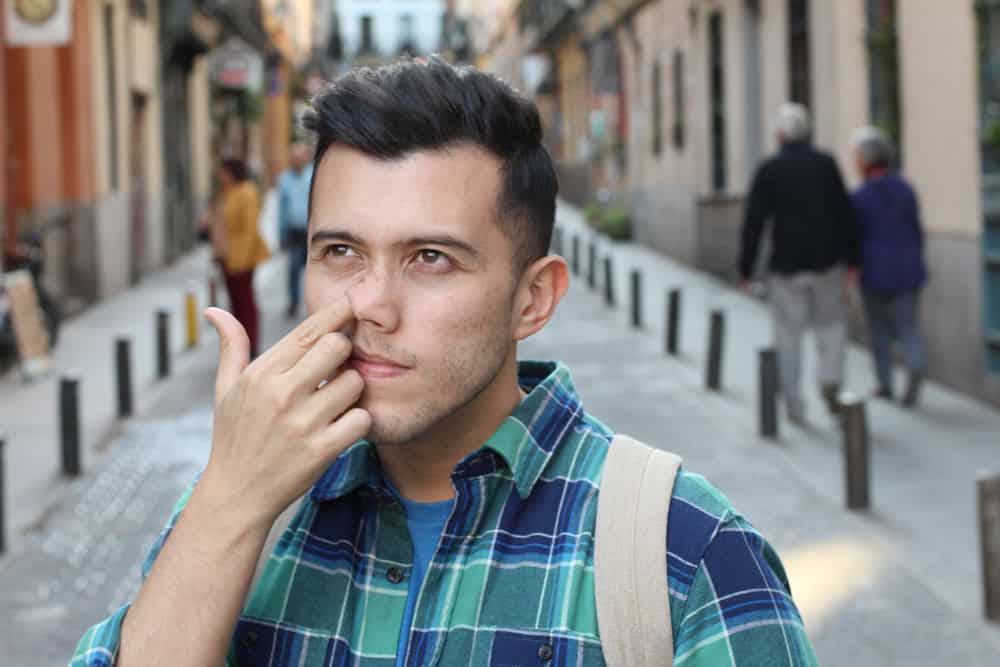 Man picking his nose. 