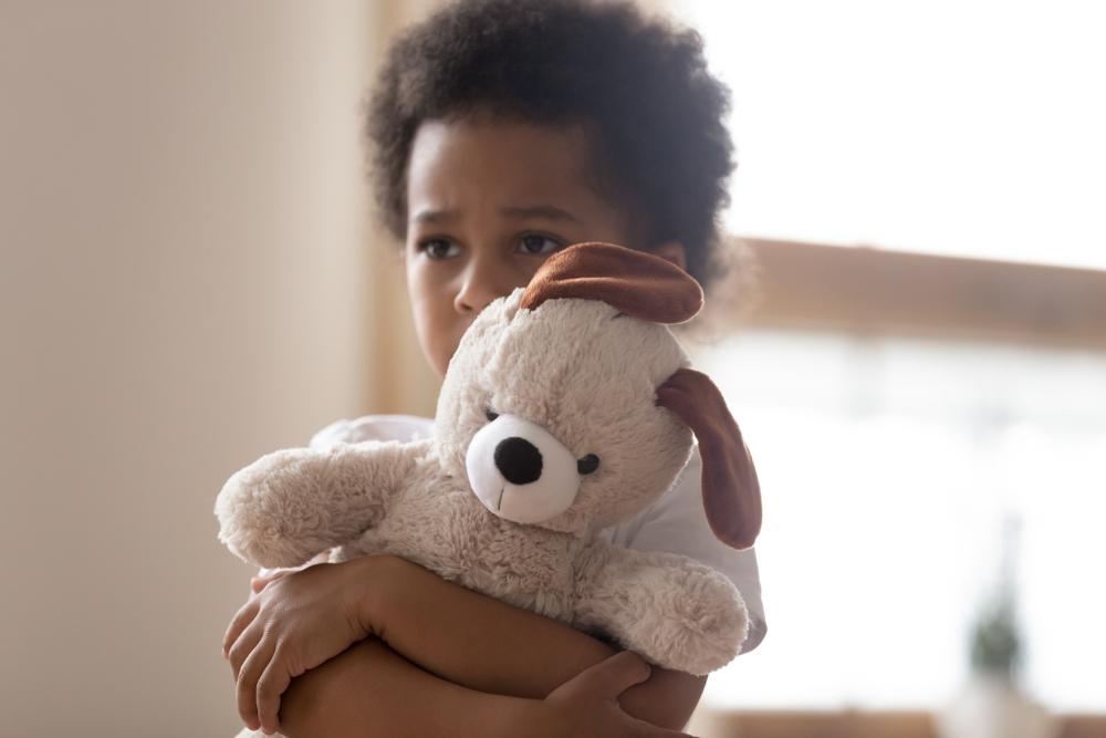 Little girl with her teddy bear.