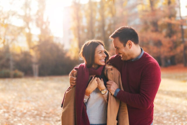 Couple walking in the park, on a cold morning