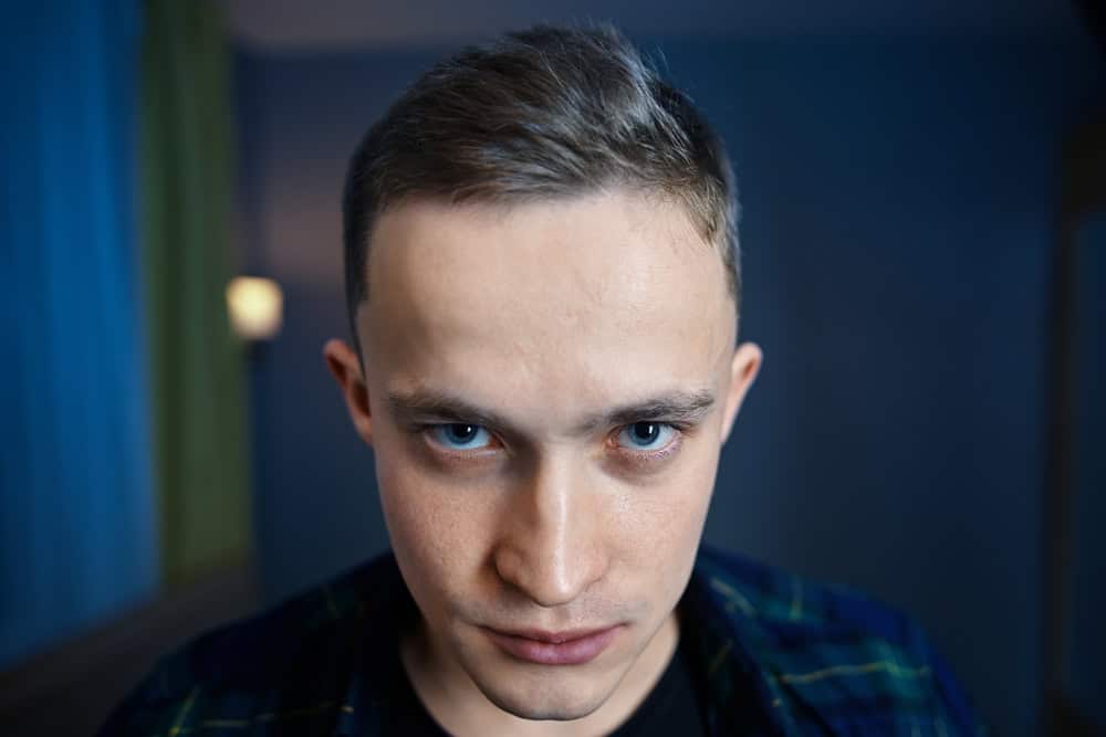 Young man with a paranoid look.