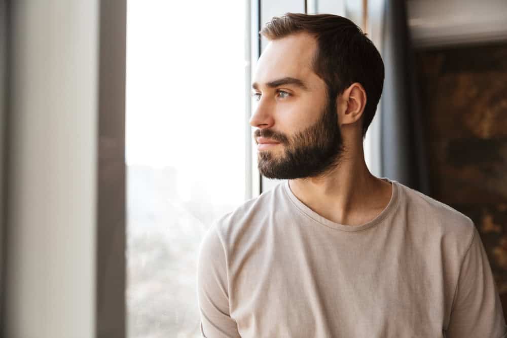 Man looking out his window.