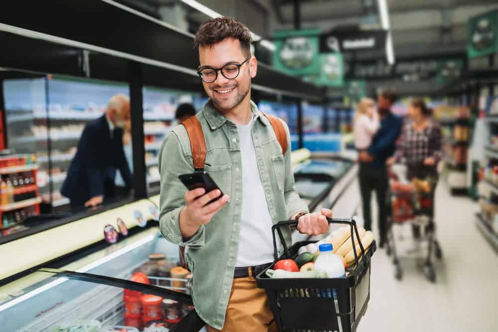 Young man buying groceries.