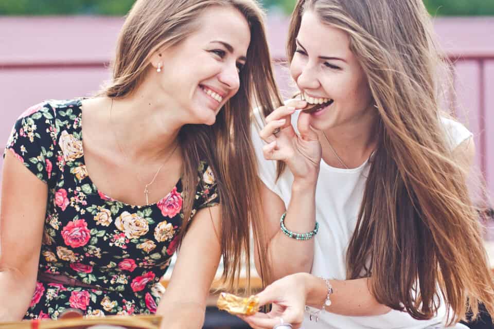 Two girlfriends sharing a meal.