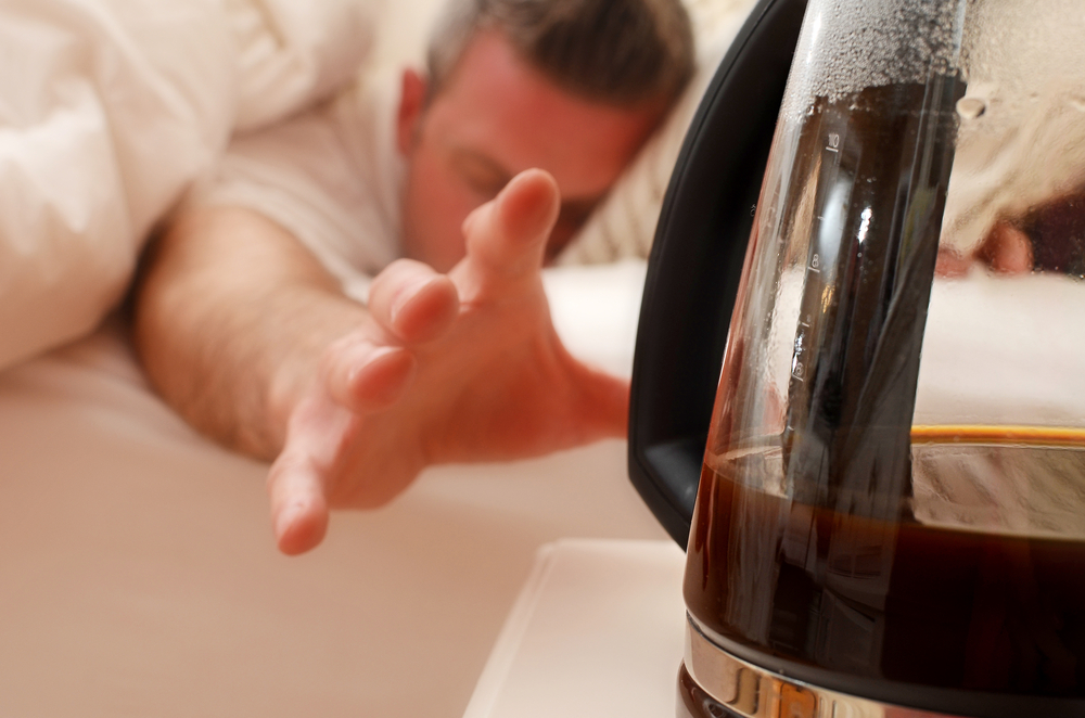Man reaching for his morning coffee.