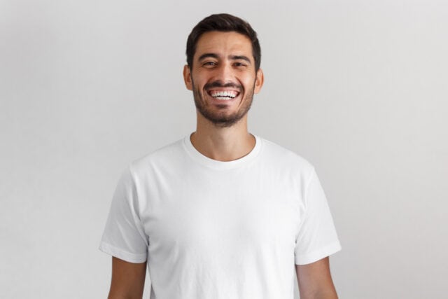 Man smiling looking happy.