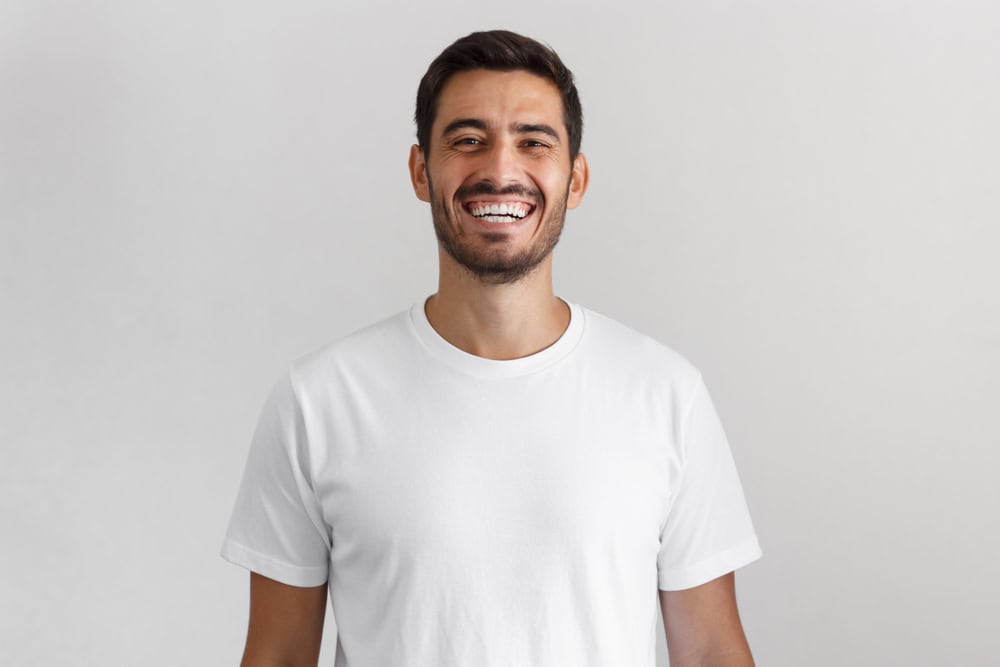 Man smiling looking happy.